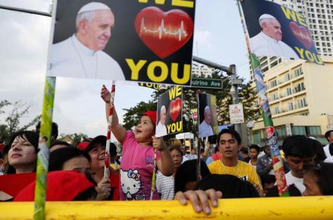 The faithful wait behind barricades for the arrival of Pope Francis in Manila, Philippines, Thursday, Jan. 15, 2015 