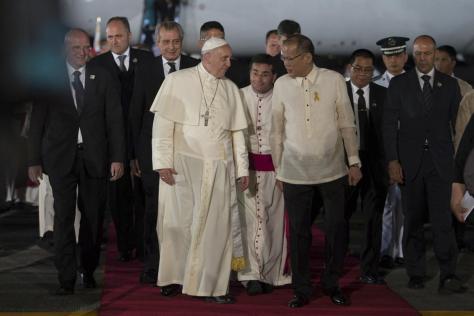 Pope Francis is greeted by Philippines' President Benigno Aquino (centre R) upon his arrival at Villamor Air Base for a state and pastoral visit, in Manila
