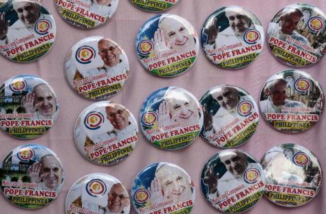 Pope Francis souvenirs are displayed by street vendors in Manila, Philippines, Thursday, Jan. 15, 2015.